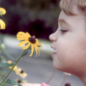 Chloe smelling flower again